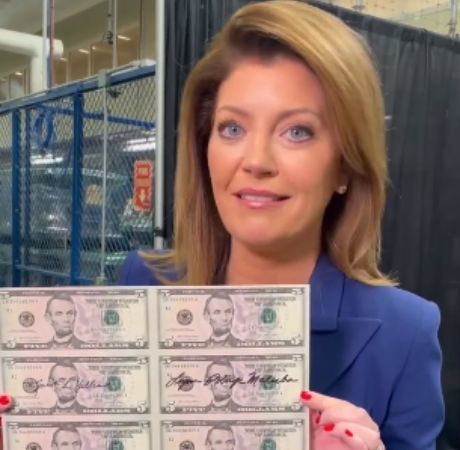 Riley Norah Tracy's mother, Norah O'Donnell holding the henew U.S. currency that has two women’s signatures. 